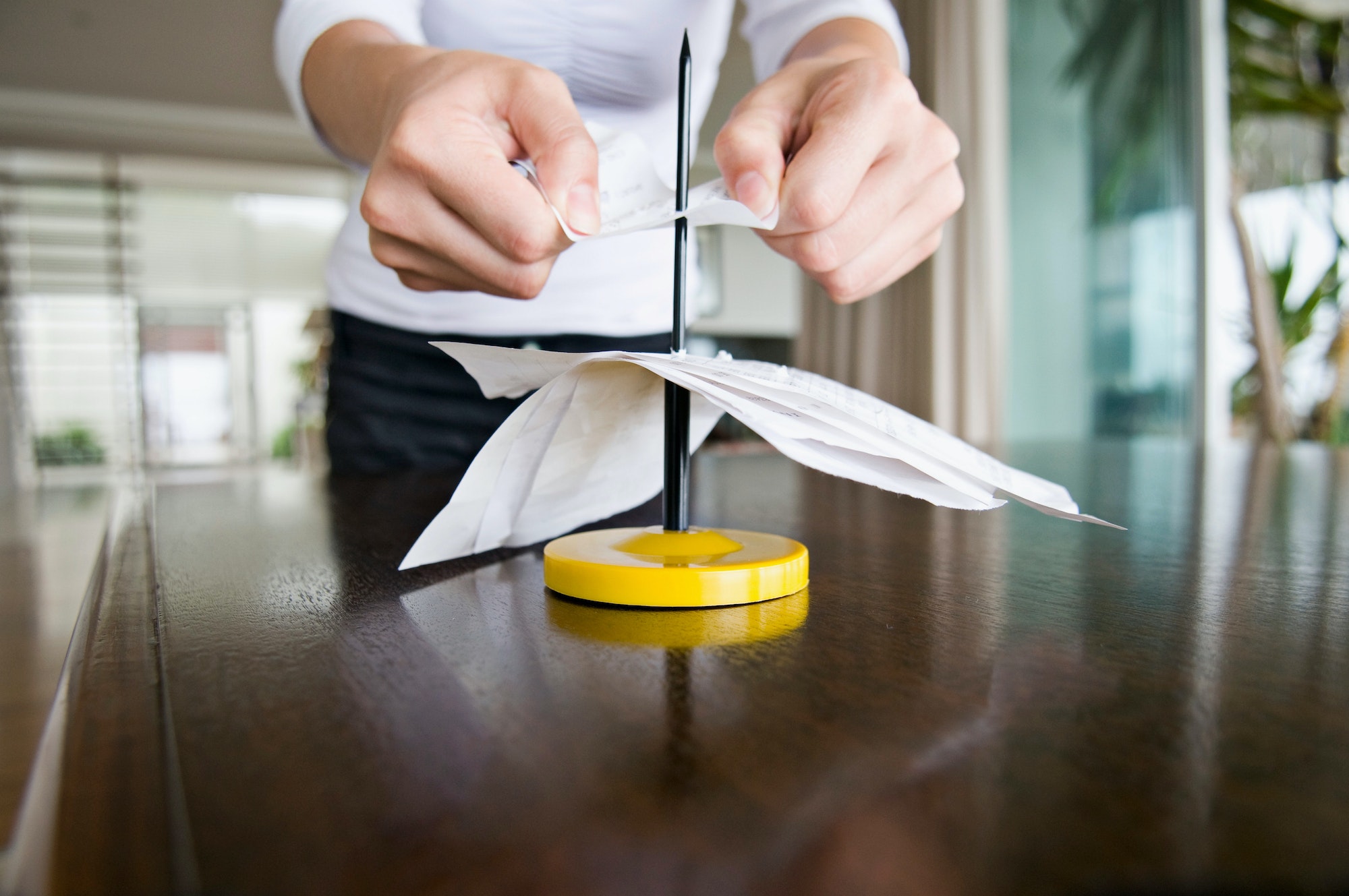 A female spiking her receipts.