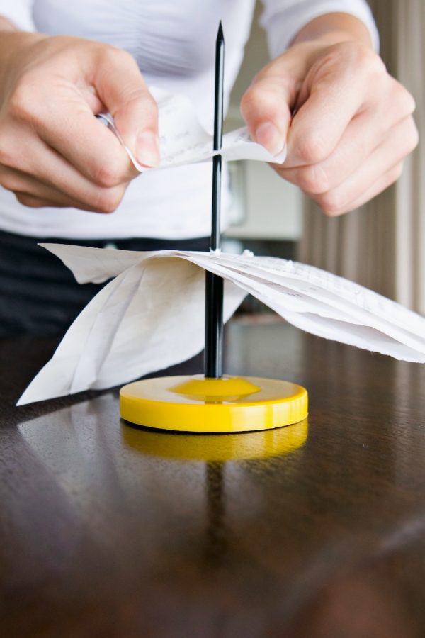 A female spiking her receipts.